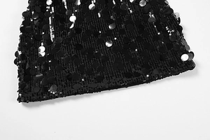 Detail of heavy-duty black sequins embroidery on a sexy bodycon dress hemline