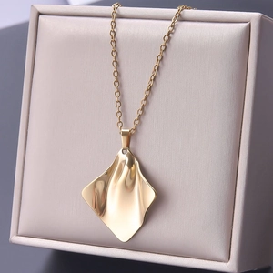 Detail showing gold 18k plated stainless steel necklace with irregular wave pendant