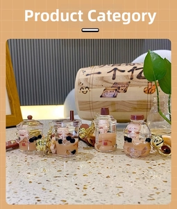 Detail view of four creative bubble tea bear keychains with liquid and floating pearls