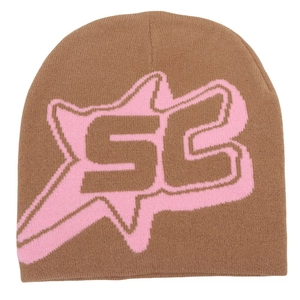 Detailed close-up of brown knit beanie featuring pink SB letter embroidery and star pattern