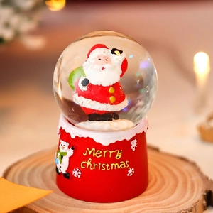 Christmas Santa Claus snow globe with glowing tree and wooden base on festive lights