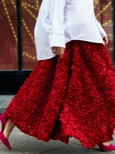 Detail of red 3D petal texture maxi skirt paired with white shirt and pink high heels