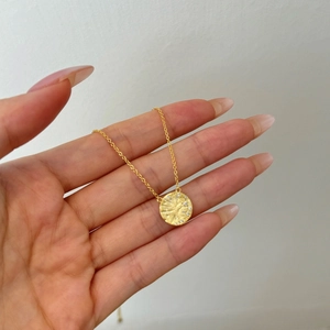 Detailed view of S925 silver gold-plated necklace with a hammered star disc pendant