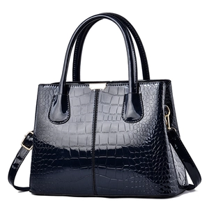 Glossy black faux crocodile leather handbag with top handles and adjustable strap for women