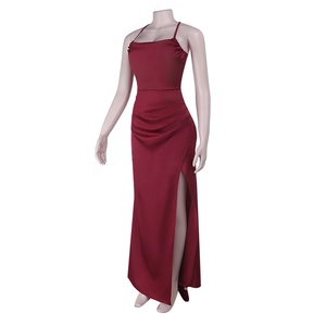 Detail of burgundy satin evening dress featuring a high side slit and thin spaghetti straps
