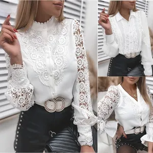 Detail of white lace stitching on long sleeve shirt with floral embroidery and buttons