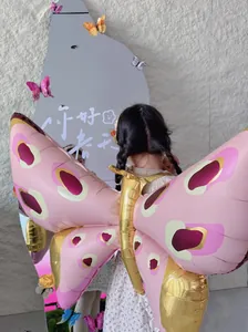 Rear view of a girl wearing pink and gold inflatable butterfly wings for kids party