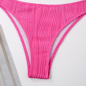 Detail of pink ribbed bikini bottom showing high-quality stitching and textured fabric