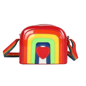 Vibrant rainbow striped crossbody bag with red heart patch and glossy leather finish