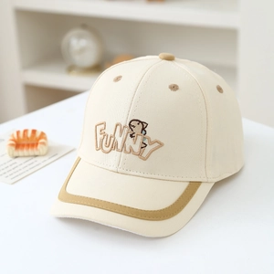 Detail of funny dinosaur embroidery and quality stitching on a beige kids baseball cap