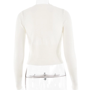 Detail of ribbed knit cuffs and hem on slim fit white long sleeve cropped sweater