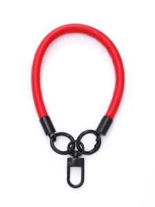 Close-up of a red leather phone wrist strap with sturdy black metal ring connectors