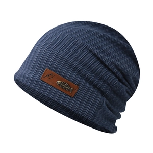 Detail of navy blue ribbed beanie with brown leather patch and fishbone metal emblem