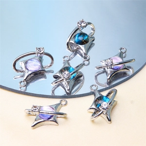 Macro detail of blue and purple gradient star pendants with sparkling cubic zirconia