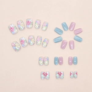 Macro shot of detachable floral press-on nails with blue cat-eye finish and hand-painted art