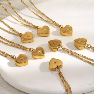 Set of eight 18K gold plated heart necklaces with colorful zircon studs on a white base