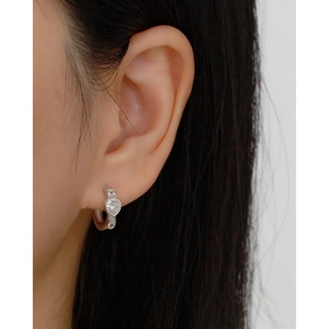 Close-up of heart-shaped s925 silver hoop earrings with sparkling zircon on ear