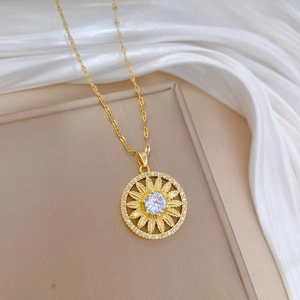 Elegant gold sunflower necklace with sparkling crystals on a white silk background