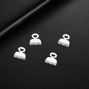 Four silver stainless steel heart-shaped mini comb pendants on black leather background