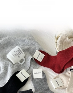 Detail of colorful knit wool socks in combed cotton featuring various seasonal tones