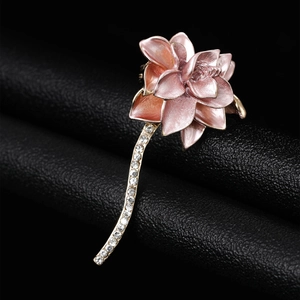 Detail of pink enamel lotus brooch with gold stem and sparkling crystal rhinestones