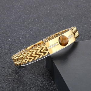 Detail of gold Cuban chain bracelet with tiger eye stone inlay and pavé diamond accents