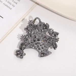 Detailed back view of a flower basket brooch showing the safety pin fastener and finish