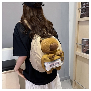 Detail of beige Capybara backpack featuring clear window and mini Chewy Vuitton coin pouch