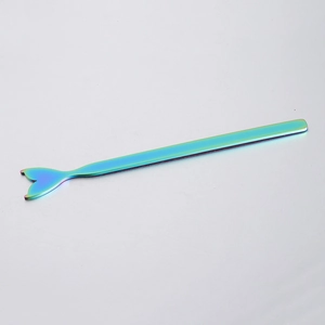 Macro detail of rainbow plated stainless steel mermaid tail stirring wand with mirror finish