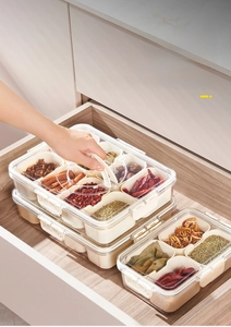 Detail view of divided spice box in drawer with transparent lid and eight compartments