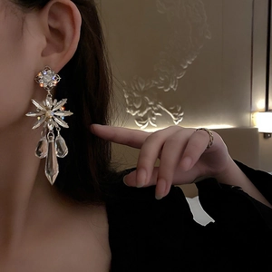 Silver crystal flower drop earrings with snowflake star design and water drop tassels