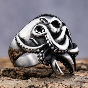 Gothic octopus tentacle skull ring in vintage silver finish on natural wood background