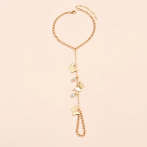Detail of gold butterfly finger bracelet with sparkling rhinestones and delicate chains