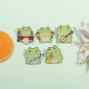 Set of five cartoon green frog enamel pins playing musical instruments on a green background