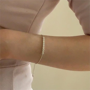 Minimalist S925 sterling silver flower bracelet with sparkling cubic zirconia on wrist