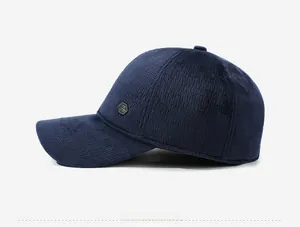 Side view of dark blue corduroy baseball cap featuring a premium metal hexagon logo