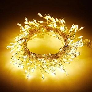Close-up of flexible copper wire LED string lights with warm yellow festive glow