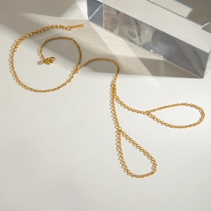 Minimalist gold stainless steel finger bracelet with elegant chain design on white background