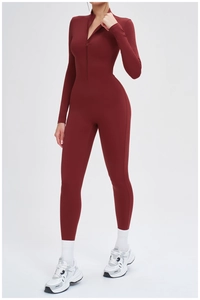 Macro detail of wine red thermal yoga bodysuit with half-zipper collar and sleek finish