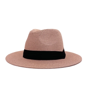 Detailed view of lightweight woven straw texture and stylish black ribbon on a wide brim hat