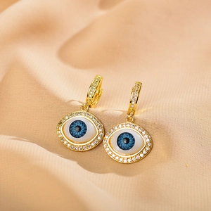 Fashionable gold evil eye drop earrings with sparkling zircon pave on champagne silk