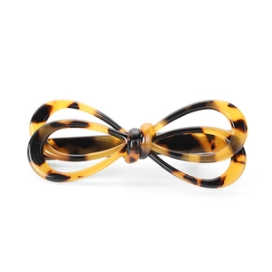 Classic tortoise shell acetate hair clip with a bow design on a clean white background