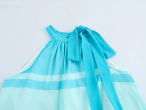 Detail of teal striped chiffon dress featuring a halter neckline and large shoulder bow