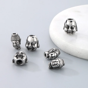 Set of six stainless steel smiling Buddha head spacer beads with antique silver finish
