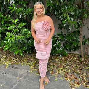 Detailed view of the 3D rose decoration and ruched texture on the pink tube midi dress