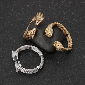 Macro detail of punk-style twisted cable bracelets featuring carved lion and wolf heads