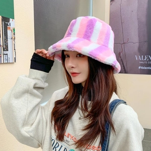 Detail of pink and white plush bucket hat with vertical striped faux fur texture