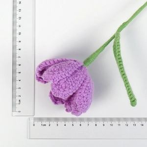 Macro shot of handmade crochet purple tulip showing dimensions with two clear rulers