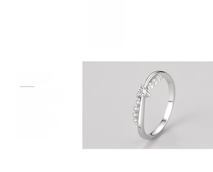 Macro detail of s925 silver crossover heart ring with triple polished mirror finish