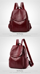 Detail showing the red leather backpack texture with embossed kangaroo logo and side pockets